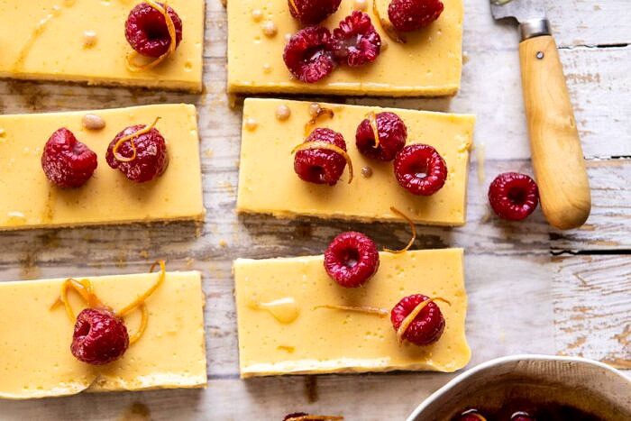 Creamy Lemon Bars with Browned Butter Raspberries | halfbakedharvest.com #lemon #brownbutter #spring #summer #easter #mothersday #brunch #dessert horizontal photo of Creamy Lemon Bars with Browned Butter Raspberries