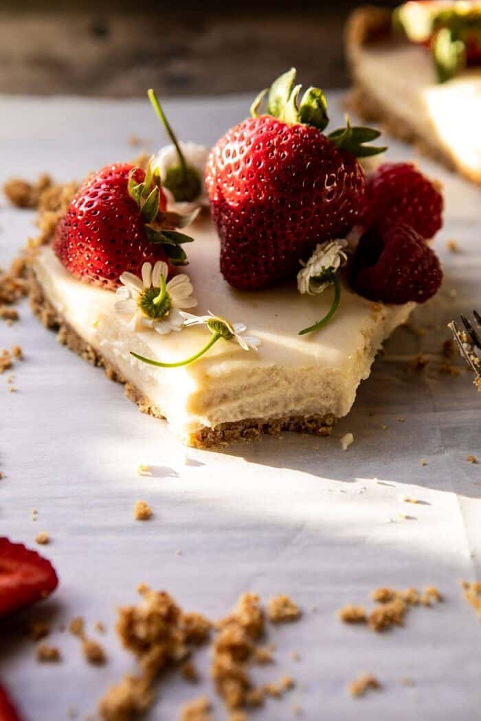 No Fuss Lemon Tart | halfbakedharvest.com #lemontart #dessert #summer #nobake #easyrecipes front on photo of No Fuss Lemon Tart slice with bite taken out