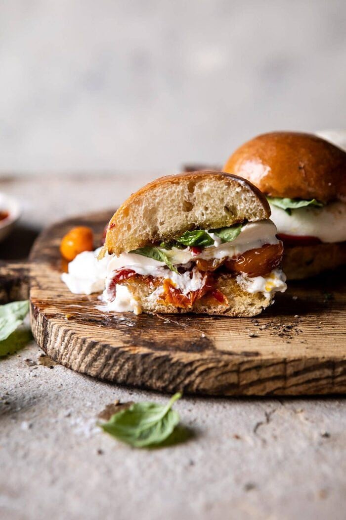 side angled photo of Roasted Caprese Burrata Sliders cut in half