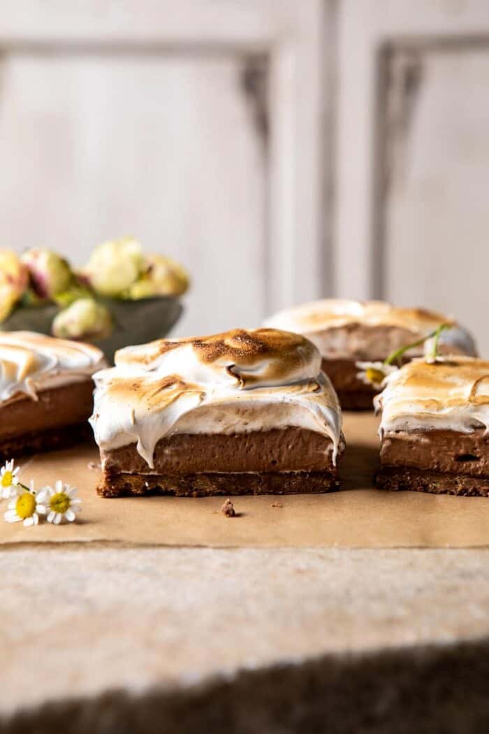 S'mores Chocolate Mousse Bars | halfbakedharvest.com #smores #dessert #chocolate #summerrecipes side angled photo of S'mores Chocolate Mousse Bars with flowers in the background