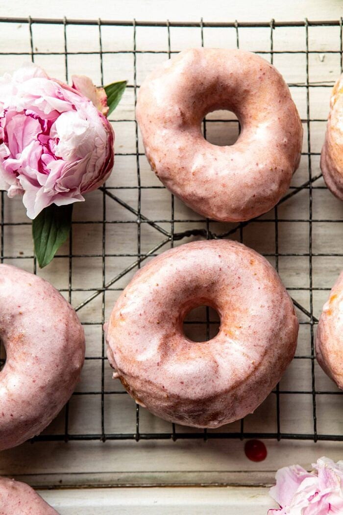 Strawberry Glazed Chai Doughnuts | halfbakedharvest.com #doughnuts #spring #strawberries overhead close up photo of Strawberry Glazed Chai Doughnuts