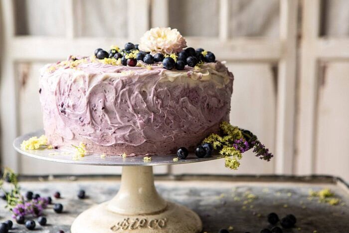 Bursting Blueberry Lemon Layer Cake | halfbakedharvest.com #bleberrycake #layercake #summerrecipes #dessert horizontal photo of Bursting Blueberry Lemon Layer Cake