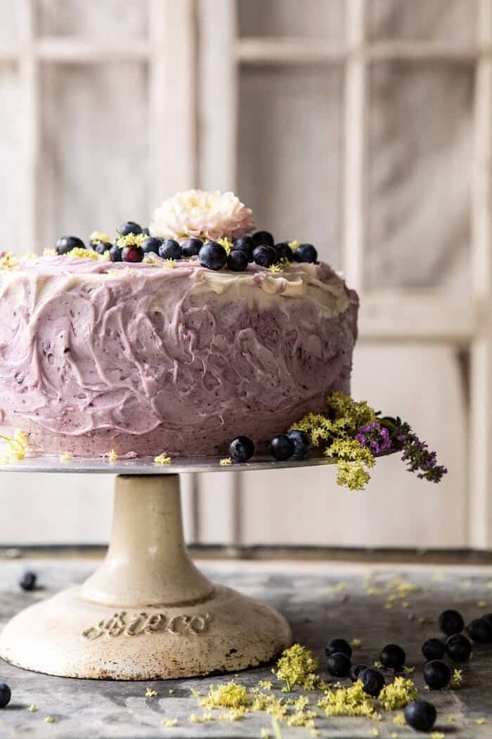 Bursting Blueberry Lemon Layer Cake | halfbakedharvest.com #bleberrycake #layercake #summerrecipes #dessert close up front on photo of Bursting Blueberry Lemon Layer Cake