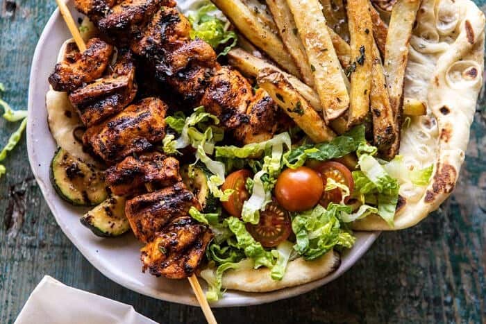 horizontal photo of Chicken Souvlaki Bowls with Garlic Fries 