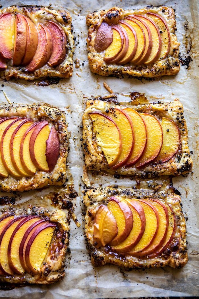 Peach Thyme Tarts | halfbakedharvest.com #peach #cheese #summer #appetizer Peach Thyme Tarts on baking sheet after baking