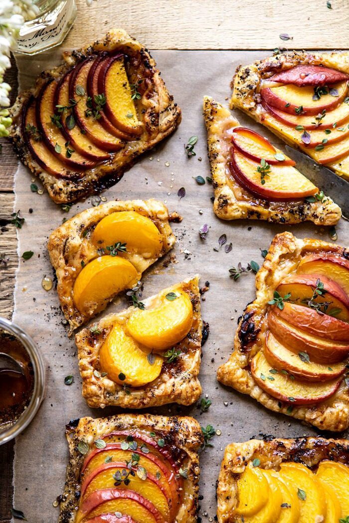Peach Thyme Tarts | halfbakedharvest.com #peach #cheese #summer #appetizer overhead close up photo of Peach Thyme Tarts with middle tart cut in half