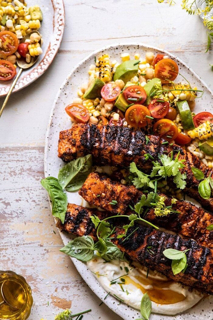 Lemon Parmesan Salmon with Corn, Tomato, and Avocado Salad | halfbakedharvest.com #salmon #grillingrecipes #dinner overhead close up photo of Lemon Parmesan Salmon with Corn, Tomato, and Avocado Salad on platter