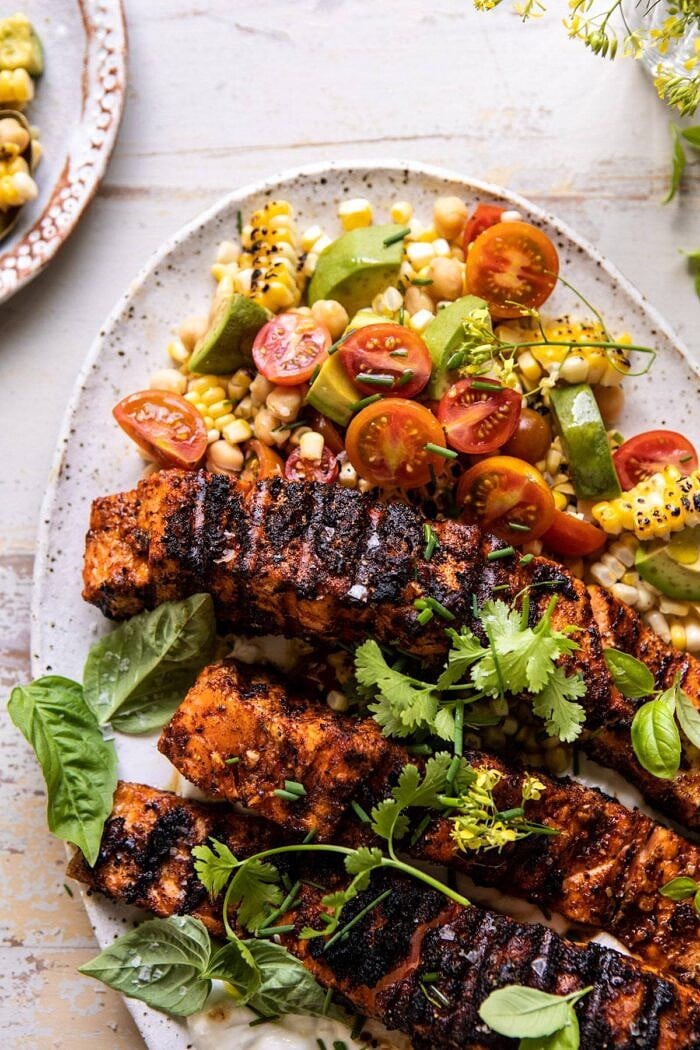Lemon Parmesan Salmon with Corn, Tomato, and Avocado Salad | halfbakedharvest.com #salmon #grillingrecipes #dinner side angled photo of Lemon Parmesan Salmon with Corn, Tomato, and Avocado Salad