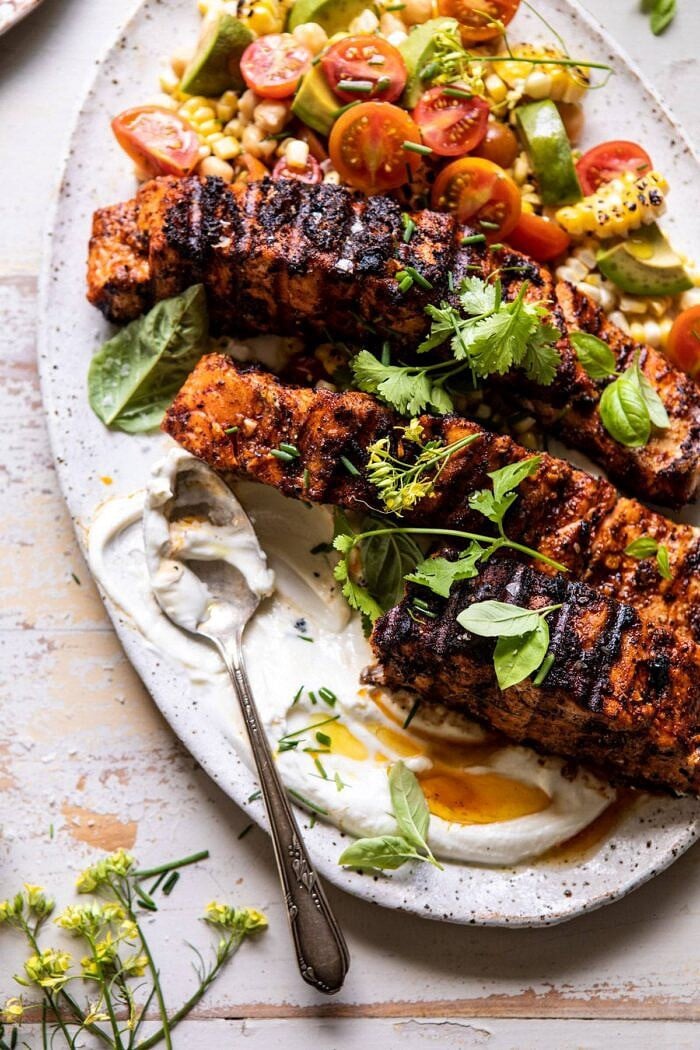 Lemon Parmesan Salmon with Corn, Tomato, and Avocado Salad | halfbakedharvest.com #salmon #grillingrecipes #dinner Lemon Parmesan Salmon with Corn, Tomato, and Avocado Salad with serving of salmon removed from platter