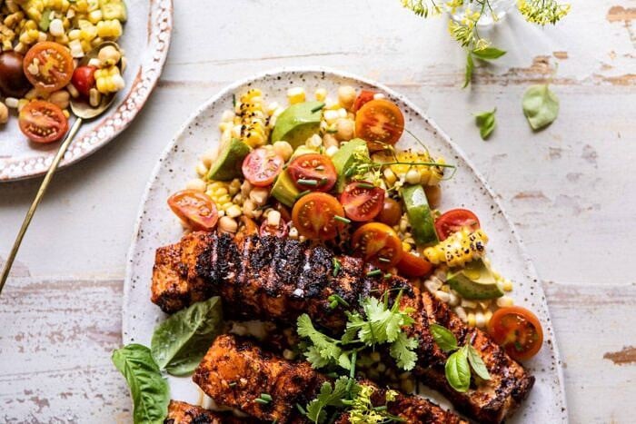 Lemon Parmesan Salmon with Corn, Tomato, and Avocado Salad | halfbakedharvest.com #salmon #grillingrecipes #dinner horizontal photo of Lemon Parmesan Salmon with Corn, Tomato, and Avocado Salad