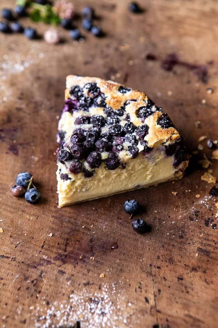 Simple Blueberry Basque Cheesecake | halfbakedharvest.com #cheesecake #blueberries #cake #easyrecipes side angled photo of Simple Blueberry Basque Cheesecake slice