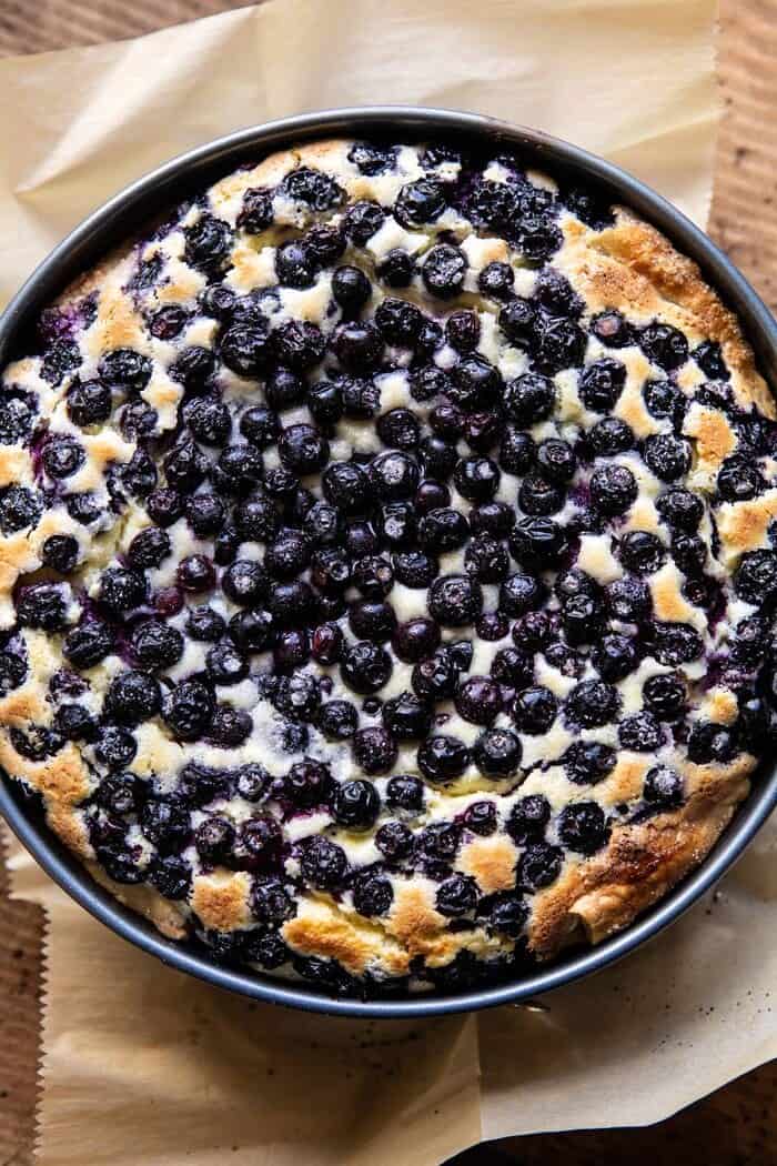 Simple Blueberry Basque Cheesecake | halfbakedharvest.com #cheesecake #blueberries #cake #easyrecipes overhead photo of Simple Blueberry Basque Cheesecake in spring form pan after baking