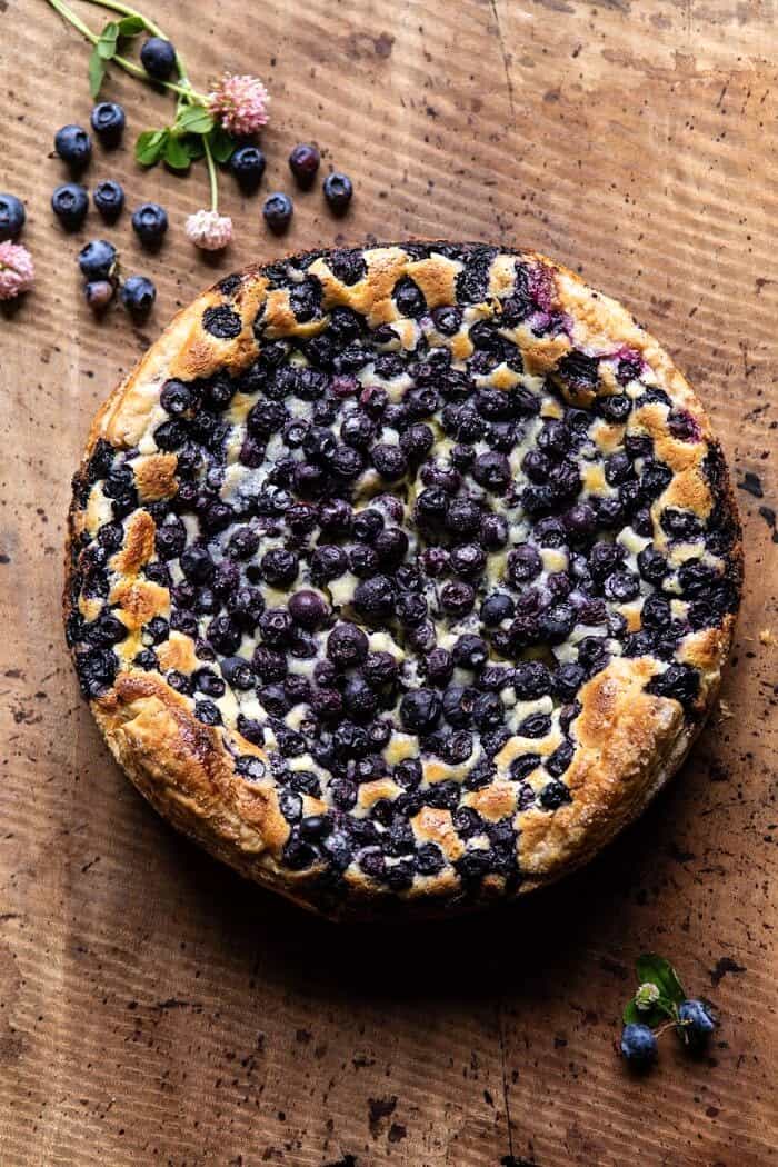 Simple Blueberry Basque Cheesecake | halfbakedharvest.com #cheesecake #blueberries #cake #easyrecipes overhead photo of Simple Blueberry Basque Cheesecake before cutting into