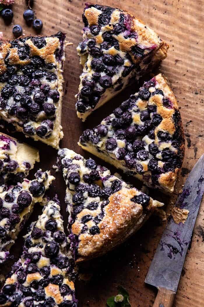 Simple Blueberry Basque Cheesecake | halfbakedharvest.com #cheesecake #blueberries #cake #easyrecipes overhead close up photo of Simple Blueberry Basque Cheesecake with 6 slices cut from cake