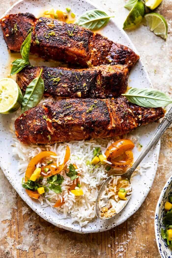 Cilantro Lime Salmon with Mango Salsa | halfbakedharvest.com #salmon #easyrecipes #healthyrecipes #dinner overhead close up photo of Cilantro Lime Salmon with Mango Salsa on serving platter
