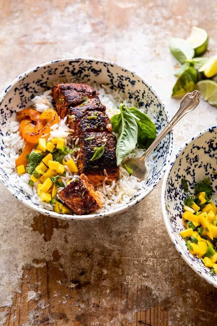Cilantro Lime Salmon with Mango Salsa | halfbakedharvest.com #salmon #easyrecipes #healthyrecipes #dinner side angled photo of Cilantro Lime Salmon with Mango Salsa with fork in bowl and bite taken out