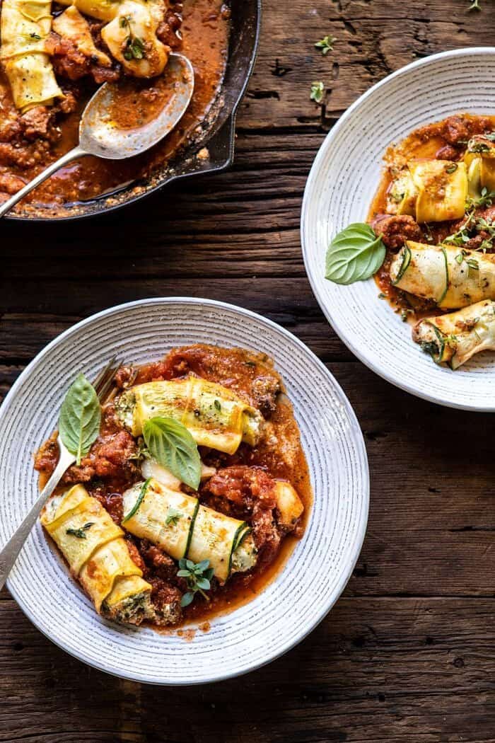 overhead photo of Spicy Pesto and Cheese Stuffed Zucchini Involtini on serving plates 