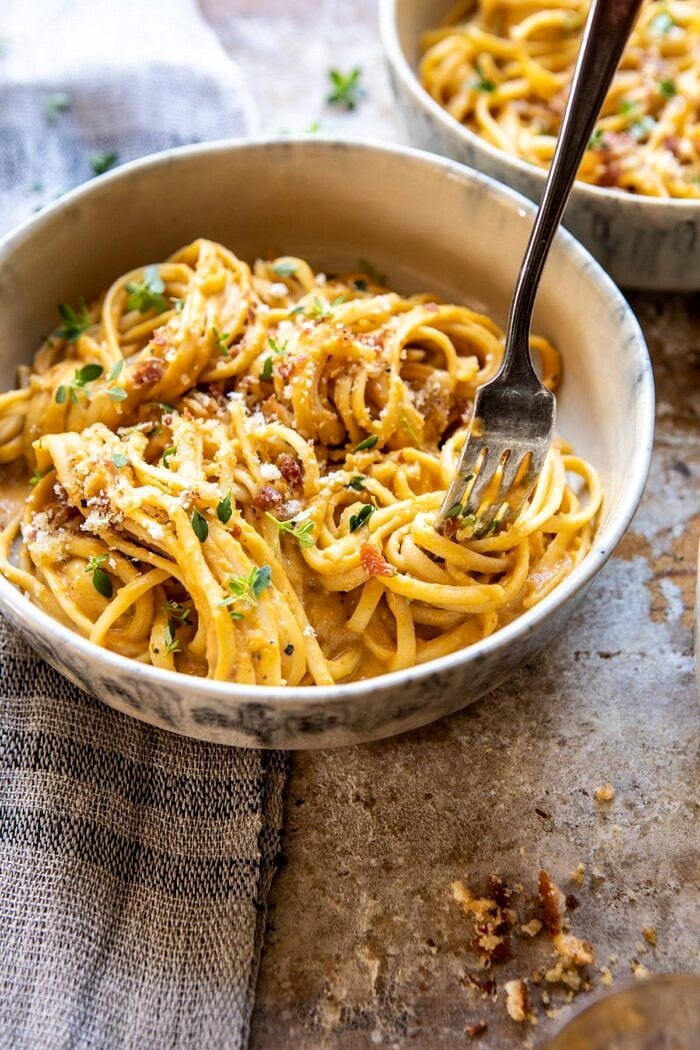 side angle photo with fork coming into pasta bowl and pasta on fork