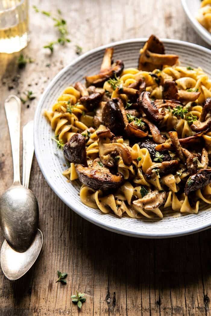 Herby Buttered Mushroom Stroganoff | halfbakedharvest.com #easyrecipes #familydinner #autumn #cozyrecipes #fallrecipes side angled close up photo of Herby Buttered Mushroom Stroganoff with 2 spoons in photo