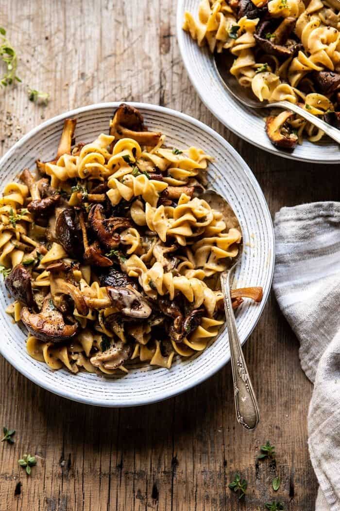 Herby Buttered Mushroom Stroganoff | halfbakedharvest.com #easyrecipes #familydinner #autumn #cozyrecipes #fallrecipes overhead photo of Herby Buttered Mushroom Stroganoff with spoon in bowl