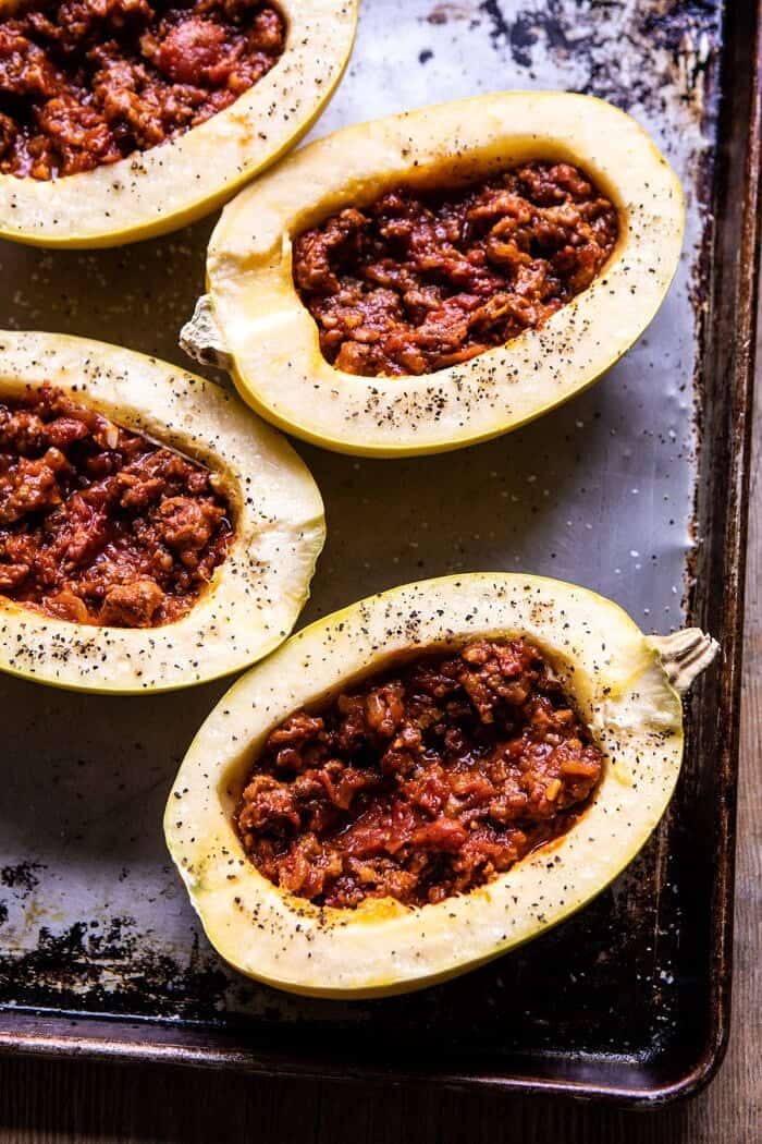 Roasted Garlic Spaghetti Squash Lasagna Boats | halfbakedharvest.com #healthyrecipes #spaghettisquash #fall #easyrecipes overhead photo of Roasted Garlic Spaghetti Squash Lasagna Boats before baking