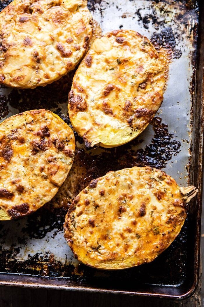Roasted Garlic Spaghetti Squash Lasagna Boats | halfbakedharvest.com #healthyrecipes #spaghettisquash #fall #easyrecipes overhead photo of Roasted Garlic Spaghetti Squash Lasagna Boats on baking sheet after baking