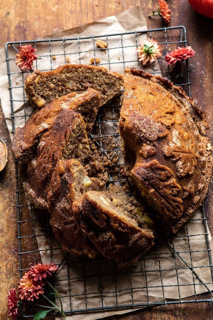 overhead photo of Spiced Pecan Apple Cider Doughnut Cake with multiple slices cut