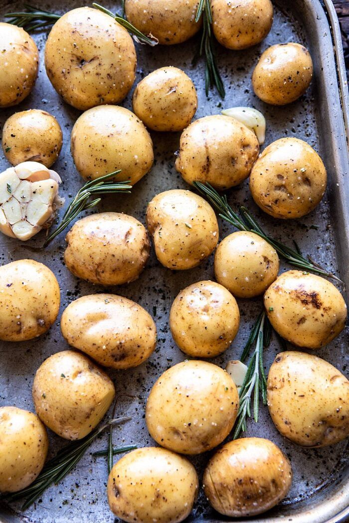 Crispy Rosemary Butter Roasted Potatoes | halfbakedharvest.com #potatoes #fall #autumn #Thanksgiving #Christmas potatoes on roasting pan