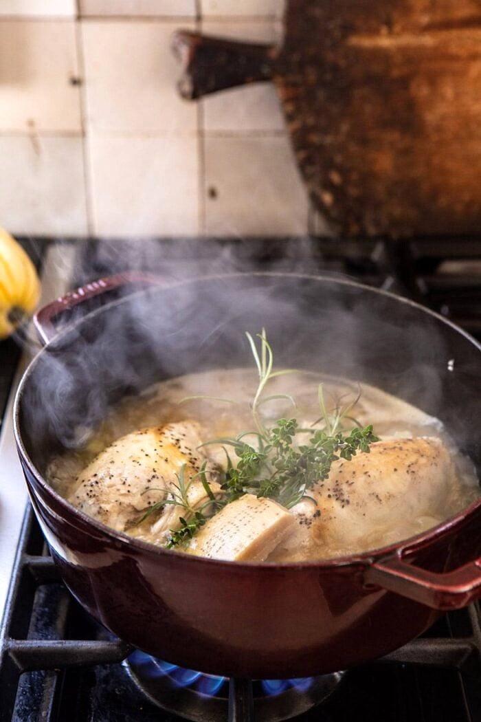 side photo of Crockpot Parmesan White Bean Chicken Soup with Roasted Delicata Squash cooking on the stove