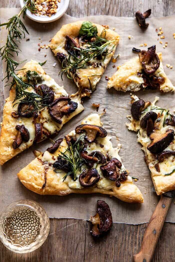French Onion Mushroom Pizza | halfbakedharvest.com #pizza #mushrooms #easyrecipes overhead photo of French Onion Mushroom Pizza with bite taken out of pizza