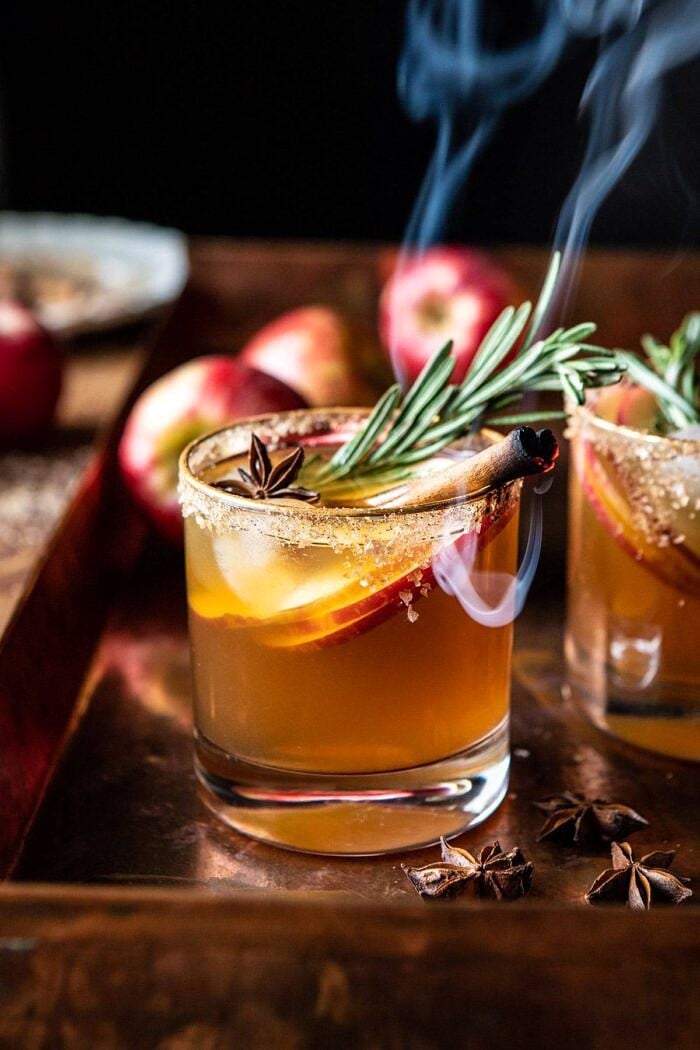 side angled close up photo of Smoky Harvest Apple Cider Margarita with smoking cinnamon stick