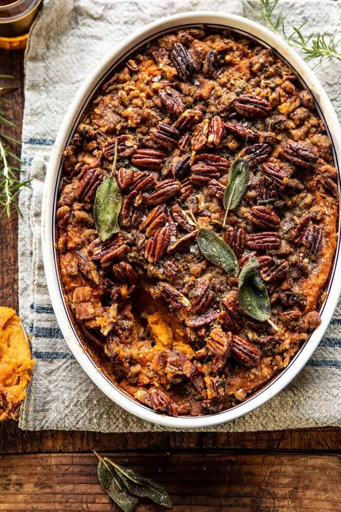 overhead photo of Bourbon Sweet Potato Casserole with Sweet n Savory Bacon Pecans with spoonful removed from casserole 