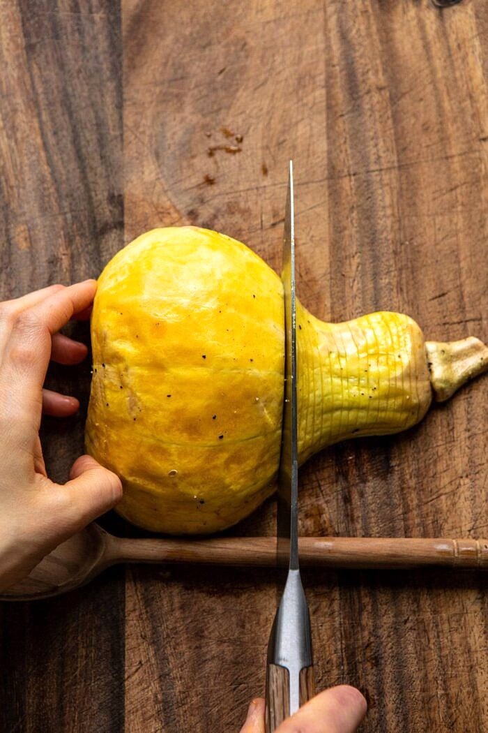 Hasselback Butternut Squash with Sage Butter and Prosciutto Breadcrumbs | halfbakedharvest.com #thanksgiving #sidedishes #butternutsquash Hasselback Butternut Squash being sliced