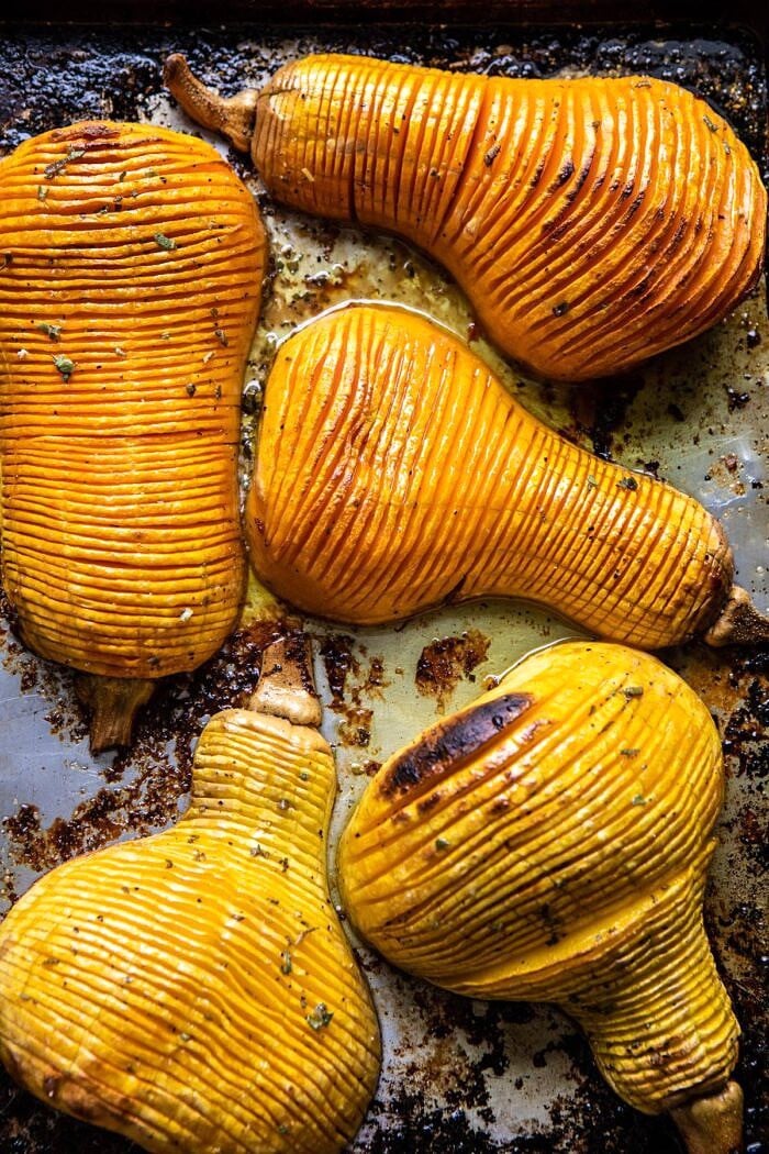 Hasselback Butternut Squash with Sage Butter and Prosciutto Breadcrumbs | halfbakedharvest.com #thanksgiving #sidedishes #butternutsquash Hasselback Butternut Squash on baking sheet