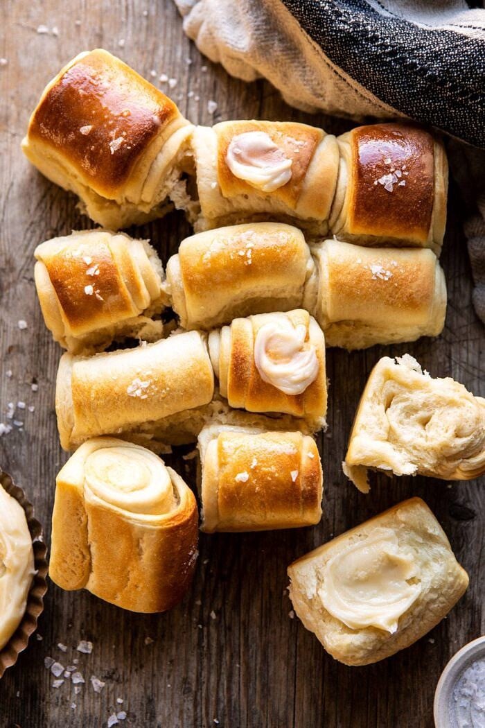 overhead photo of Salted Honey Butter Parker House Rolls with a few rolls torn apart