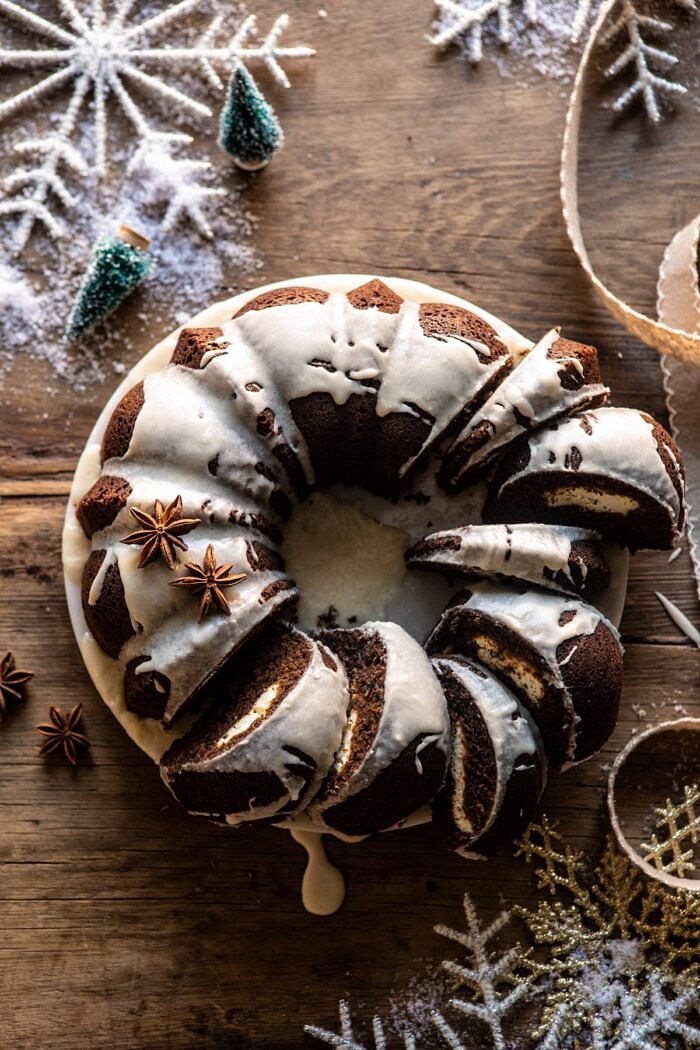 Cream Cheese Swirled Chai Gingerbread Cake | halfbakedharvest.com #gingerbread #cake #Christmas #dessert overhead photo of Cream Cheese Swirled Chai Gingerbread Cake with multiple slices of cake cut