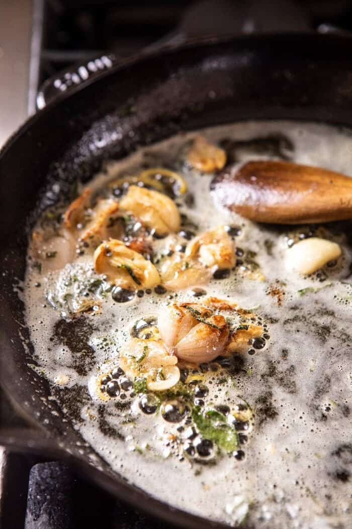 side angled photo of garlic butter in skillet browning 