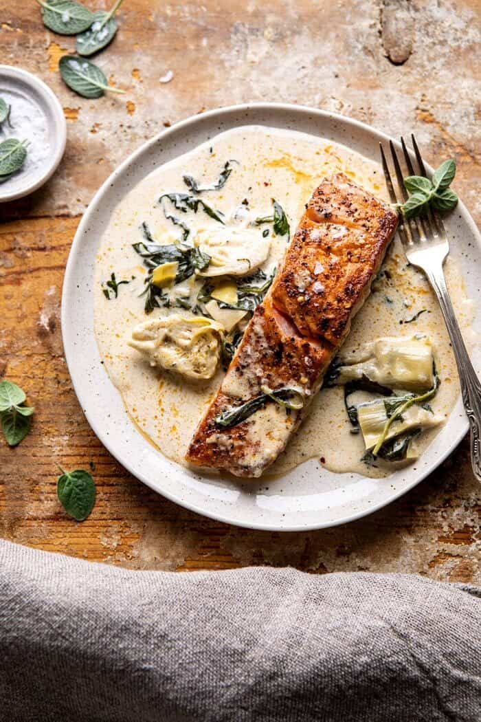 Creamy Spinach and Artichoke Salmon | halfbakedharvest.com #salmon #garlicbutter #easyrecipes