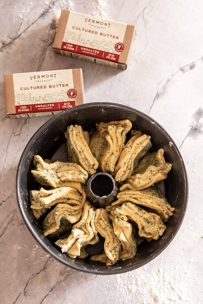 Pull-Apart Garlic Butter Bread Wreath | halfbakedharvest.com #garlicbread #Christmas overhead photo of Pull-Apart Garlic Butter Bread Wreath in bundt pan before baking