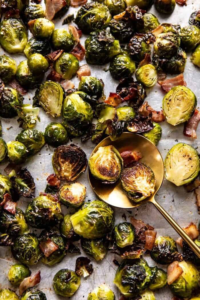 Roasted Bacon Brussels Sprouts with Salted Honey | halfbakedharvest.com #brusselssprouts #healthy Roasted Bacon Brussels Sprouts on baking sheet before plating