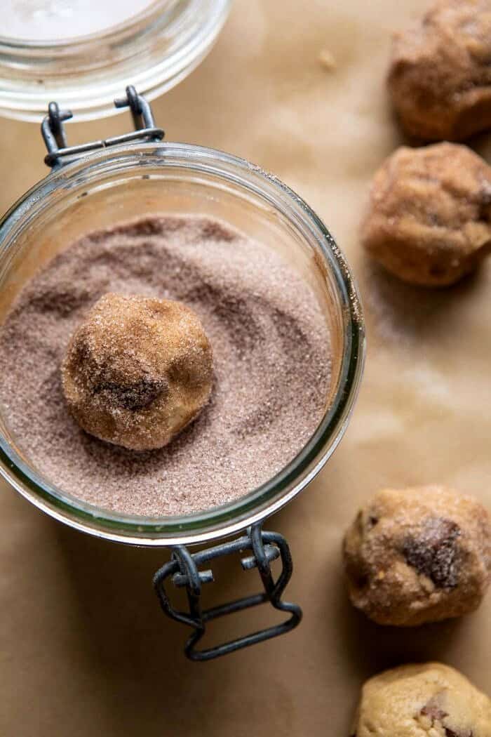 overhead photo of Salted Caramel Pretzel Snickerdoodles cookie dough being rolled in cinnamon sugar