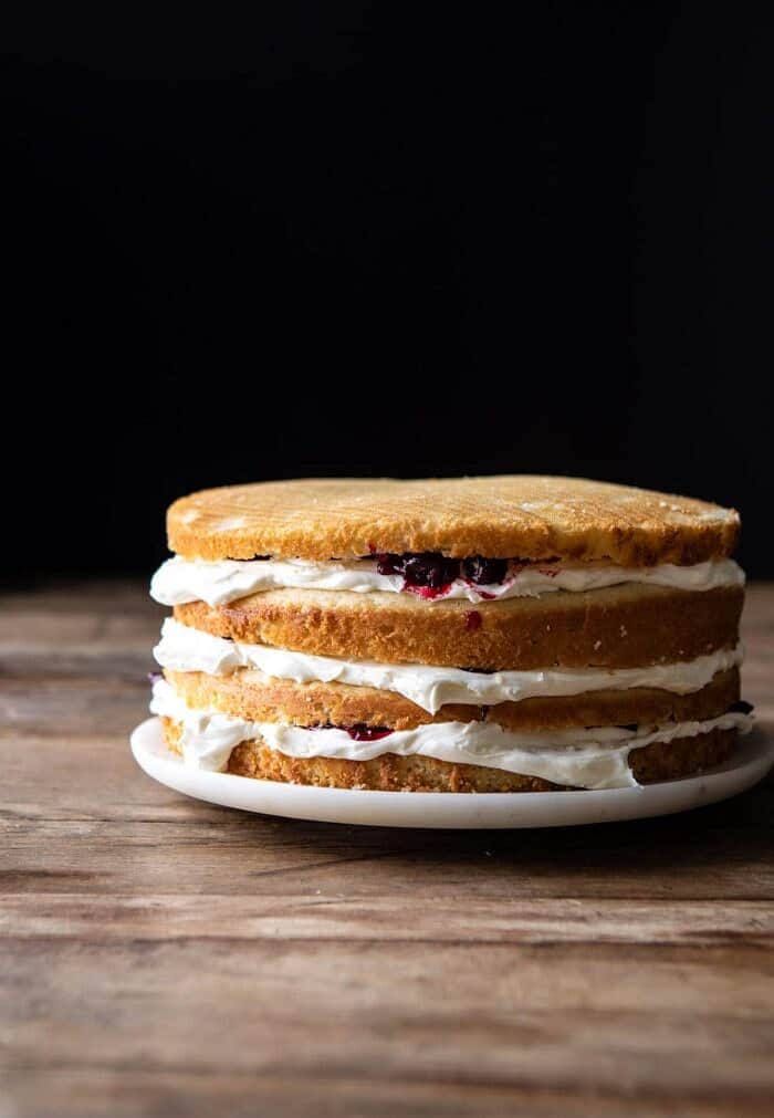 side angled photo of White Christmas Cranberry Layer Cake before frosting the outside of the cake