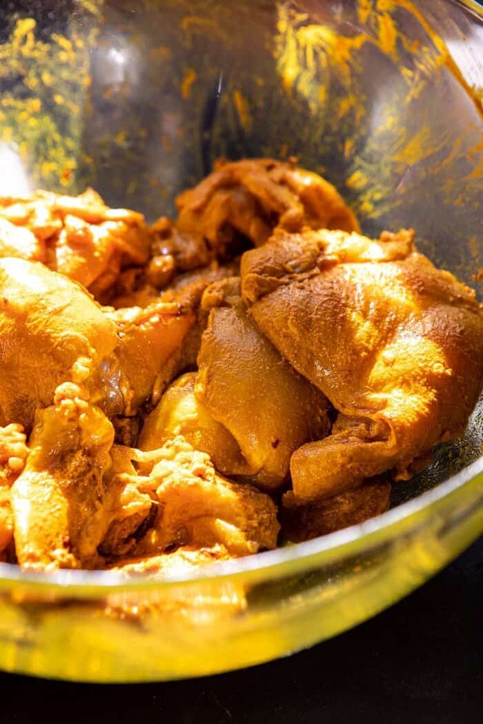 raw chicken sitting in marinade before cooking