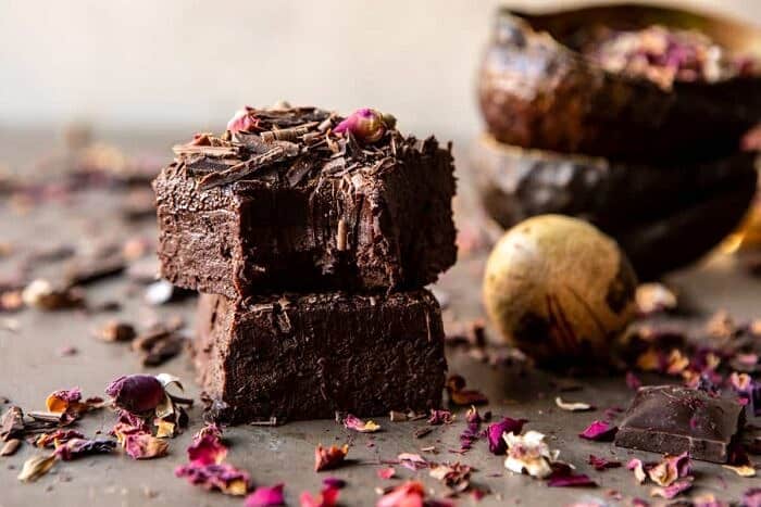 horizontal photo of Fudgy Avocado Brownies with Chocolate Fudge Frosting stack on top of each other