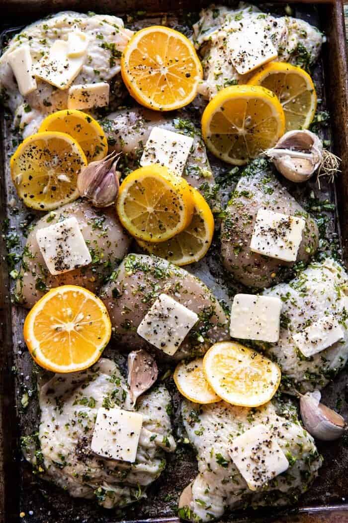Roasted Garlic Butter Chicken with Lemon Olive Dressing | halfbakedharvest.com #chicken #sheetpan #easyrecipes overhead photo of Roasted Garlic Butter Chicken on sheet pan before roasting