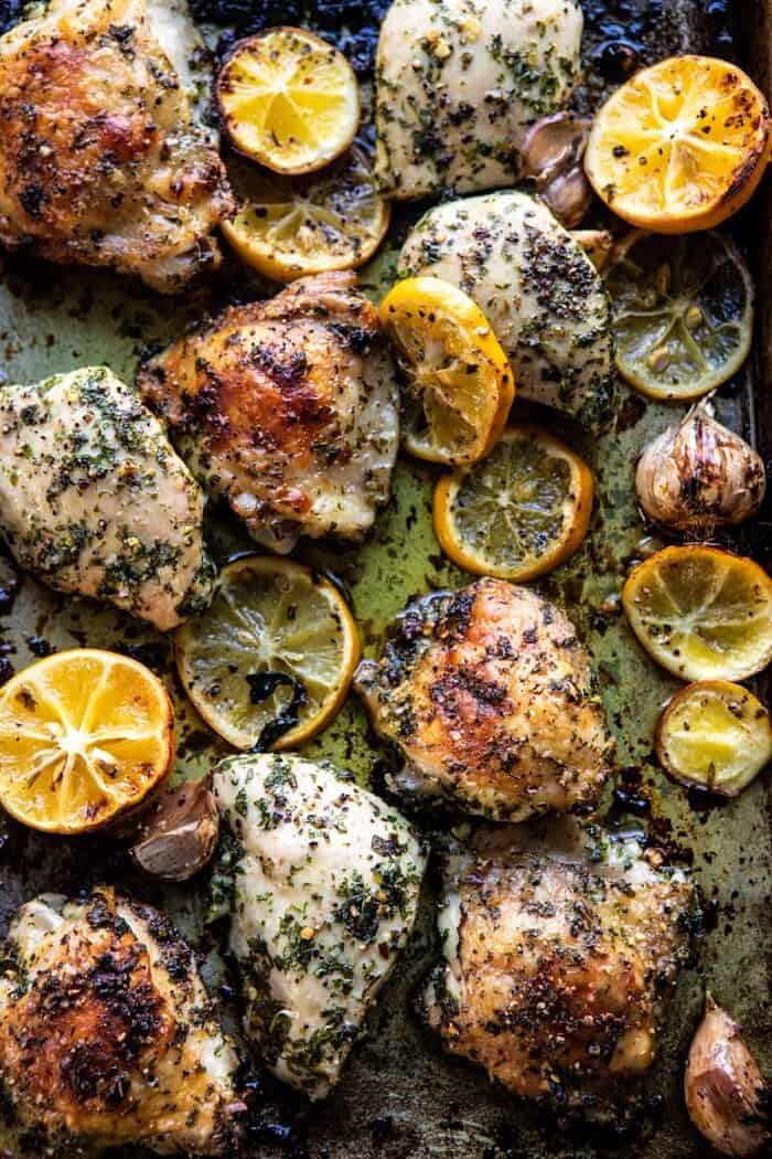 Roasted Garlic Butter Chicken with Lemon Olive Dressing | halfbakedharvest.com #chicken #sheetpan #easyrecipes overhead photo of Roasted Garlic Butter Chicken on sheet pan after roasting
