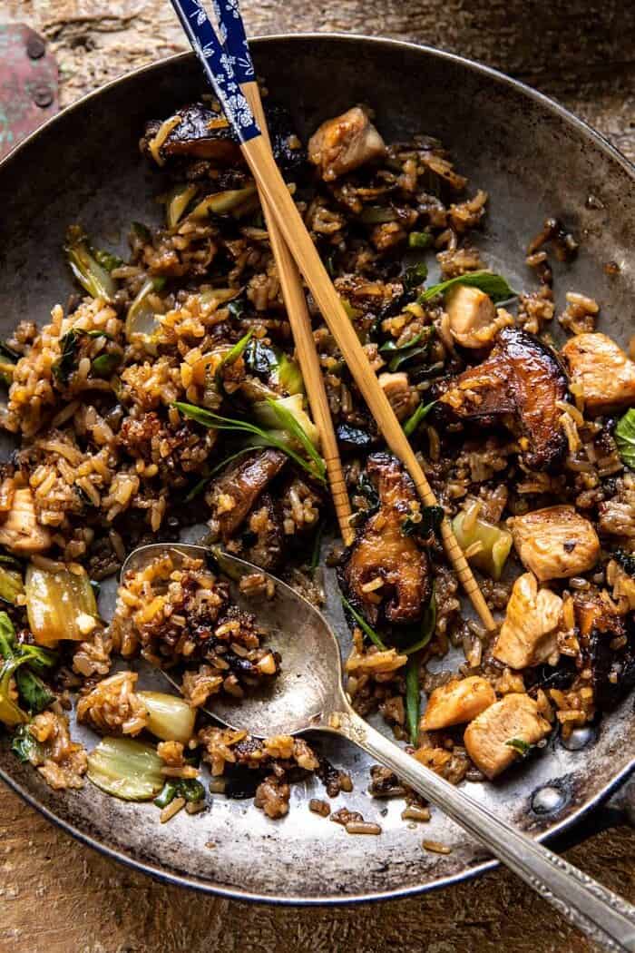 Better Than Takeout Sesame Ginger Chicken Fried Rice | halfbakedharvest.com overhead photo of Better Than Takeout Sesame Ginger Chicken Fried Rice with chopsticks in skillet to show the food has been eaten