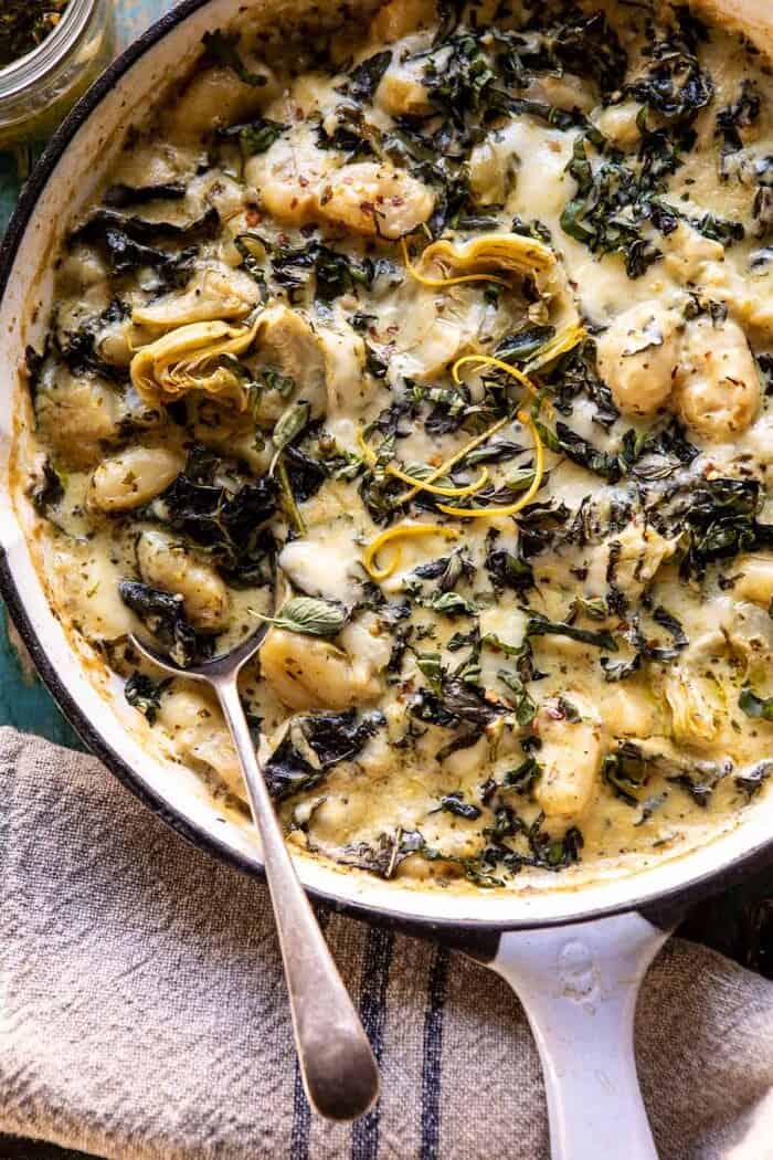 Skillet Baked Creamy Pesto Spinach and Artichoke Gnocchi | halfbakedharvest.com #gnocchi #easyrecipes #oneskillet