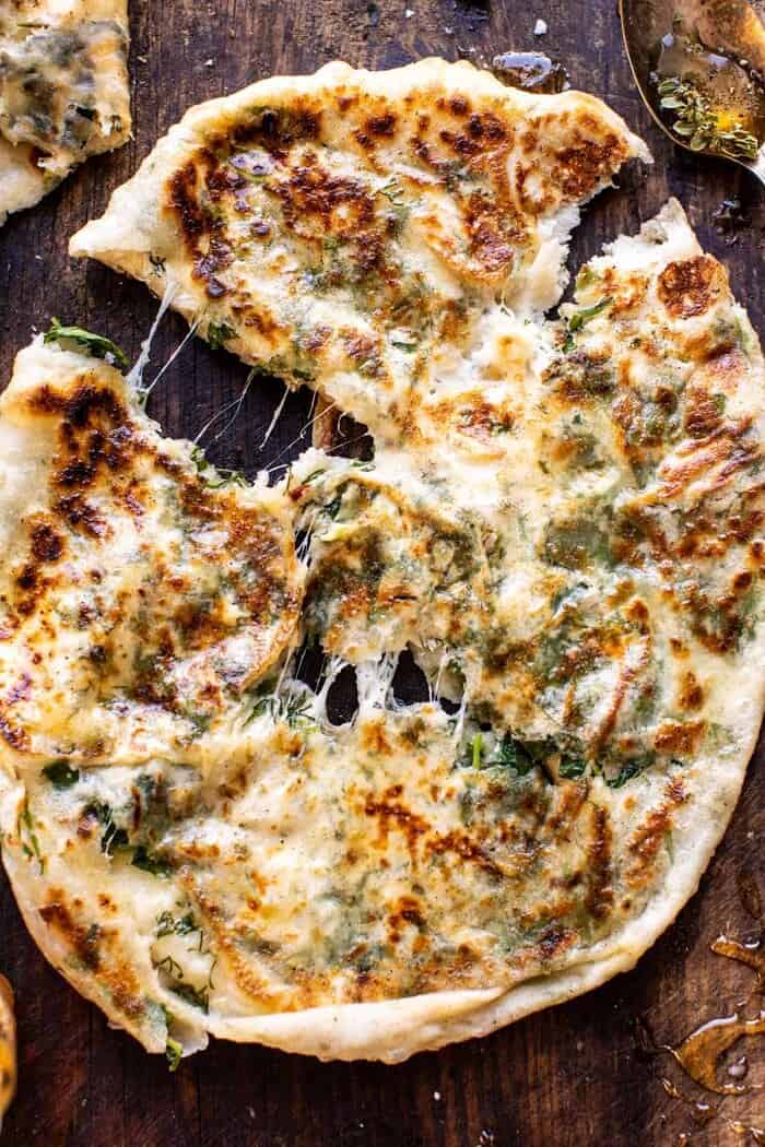 Cheesy Herb Stuffed Naan | halfbakedharvest.com overhead close up photo of Cheesy Herb Stuffed Naan