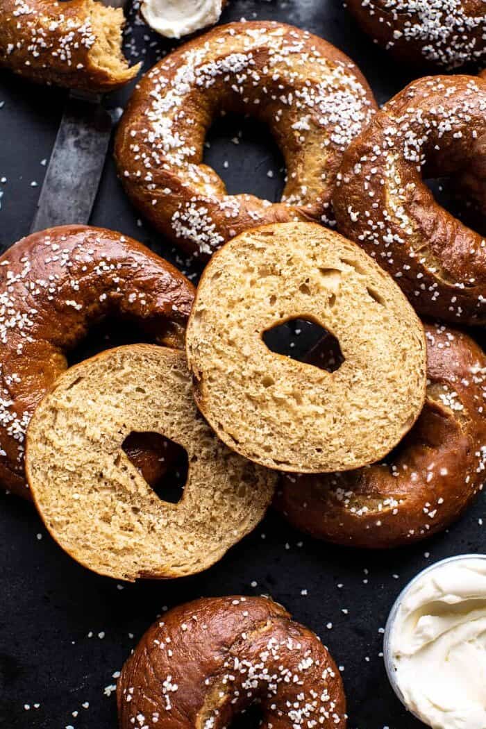overhead photo of Easy Homemade Pretzel Bagels with 1 bagel cut in half
